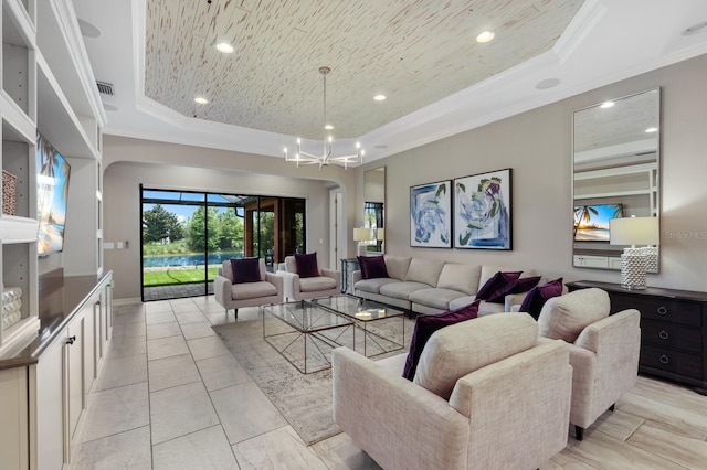 living room featuring a raised ceiling, crown molding, and a notable chandelier