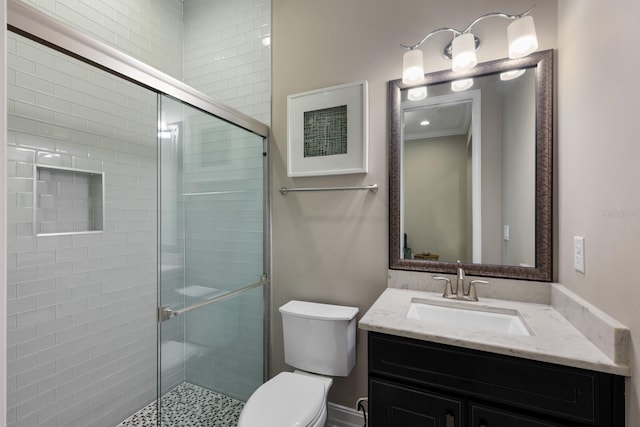 bathroom featuring vanity, an enclosed shower, and toilet