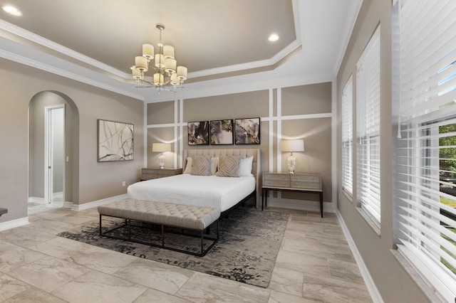 bedroom with a tray ceiling, ornamental molding, and an inviting chandelier