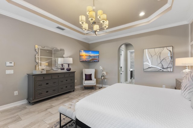 bedroom with a tray ceiling, crown molding, and a notable chandelier