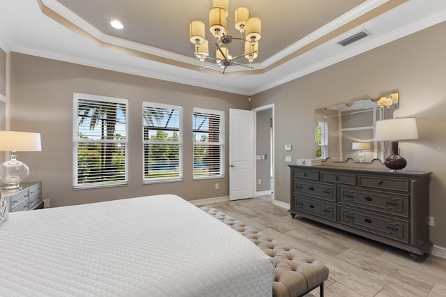 bedroom with a tray ceiling, an inviting chandelier, and ornamental molding