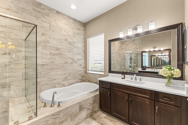 bathroom with vanity and independent shower and bath