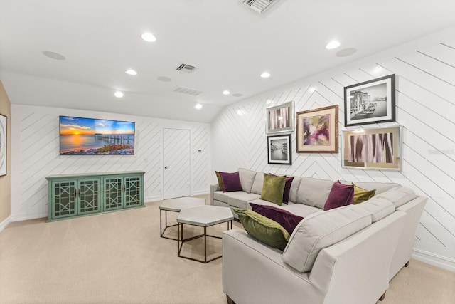 carpeted living room with vaulted ceiling and wooden walls