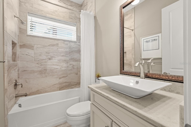 full bathroom featuring shower / tub combo with curtain, vanity, and toilet