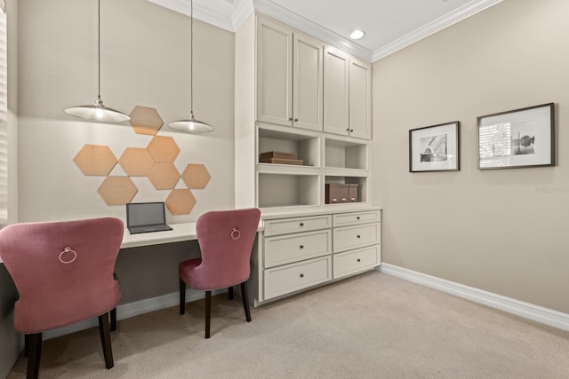 carpeted office space featuring built in desk and ornamental molding