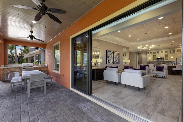 view of patio / terrace with outdoor lounge area, an outdoor kitchen, ceiling fan, and a grill