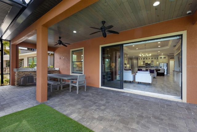 view of patio with ceiling fan and an outdoor kitchen