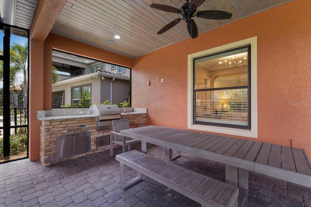 view of patio with ceiling fan, a grill, and exterior kitchen