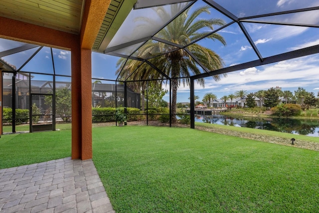 view of yard with glass enclosure and a water view