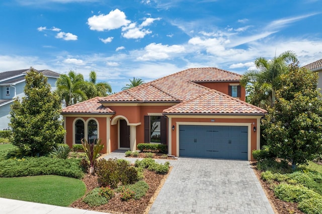 mediterranean / spanish home featuring a garage