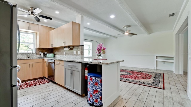 kitchen featuring stainless steel appliances, visible vents, ceiling fan, light stone countertops, and a peninsula