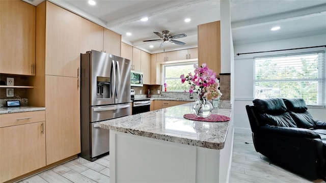 kitchen with light brown cabinetry, appliances with stainless steel finishes, backsplash, and light stone counters