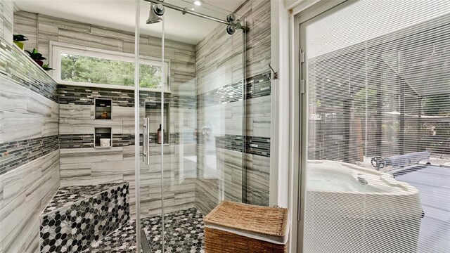 bathroom featuring a shower with door