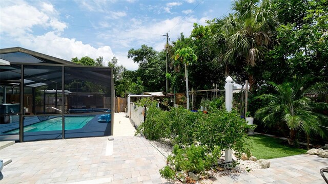 view of swimming pool with a patio and glass enclosure