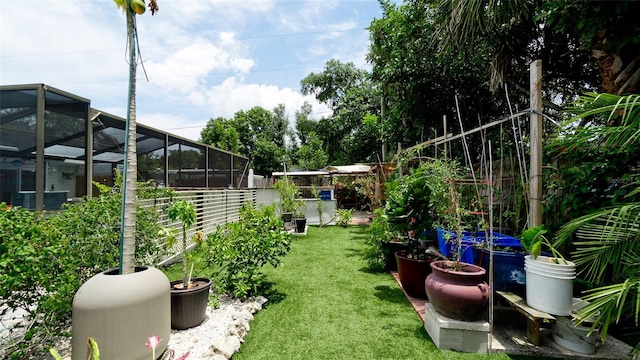 view of yard featuring a lanai and fence private yard