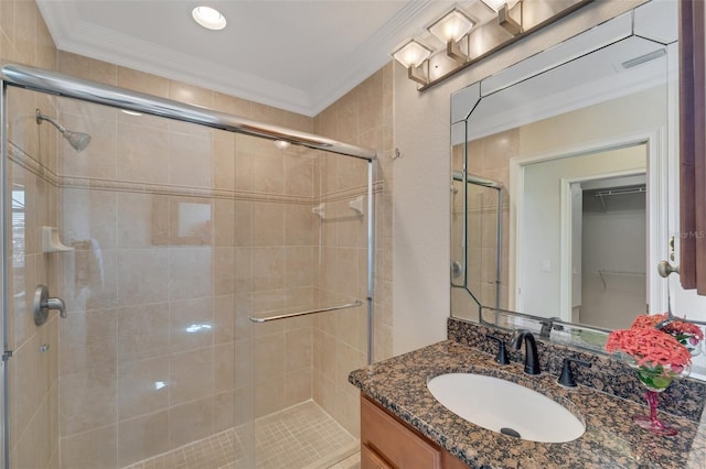 bathroom featuring vanity, walk in shower, and ornamental molding