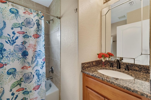 bathroom with shower / bathtub combination with curtain and vanity