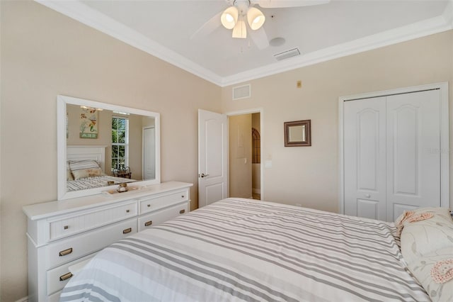 bedroom with ceiling fan, crown molding, and a closet