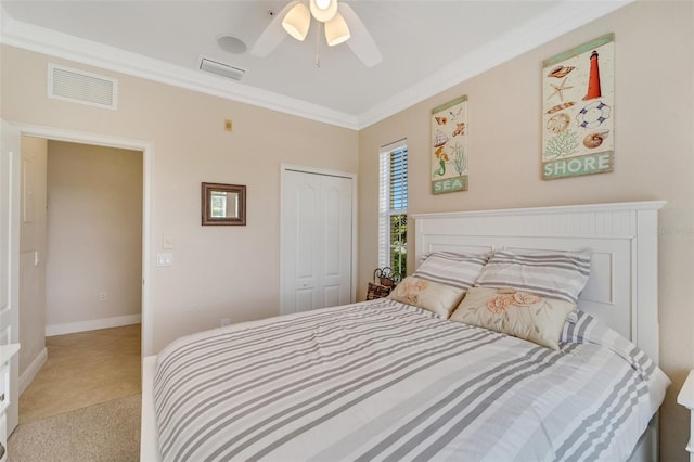 bedroom featuring a closet, carpet floors, ceiling fan, and crown molding