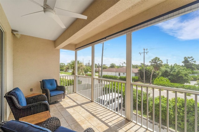 sunroom featuring ceiling fan