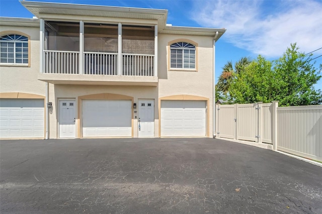 townhome / multi-family property with a garage and a balcony