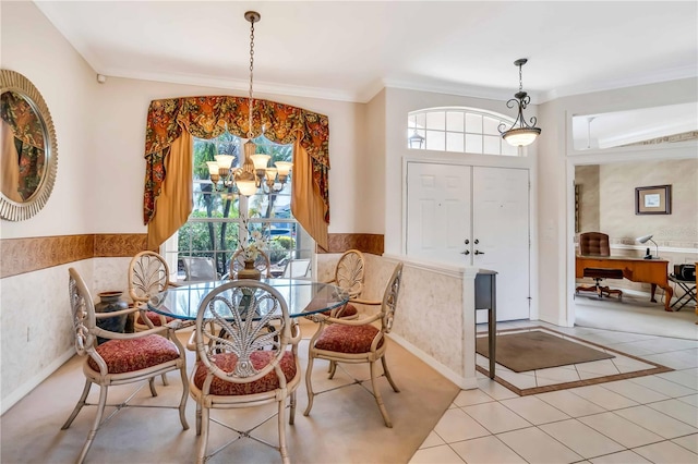 tiled dining area featuring ornamental molding and a chandelier