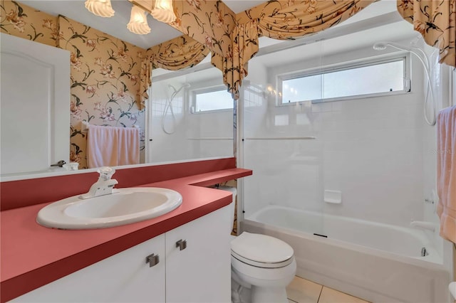 full bathroom featuring tile patterned flooring, toilet, vanity, and tiled shower / bath