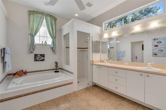 bathroom with tile patterned flooring, shower with separate bathtub, vanity, and a healthy amount of sunlight