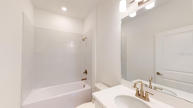 full bathroom featuring vanity, toilet, and tiled shower / bath