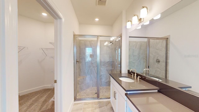 bathroom featuring vanity and a shower with door