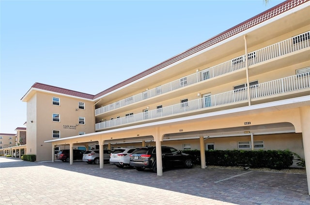 view of building exterior featuring covered parking