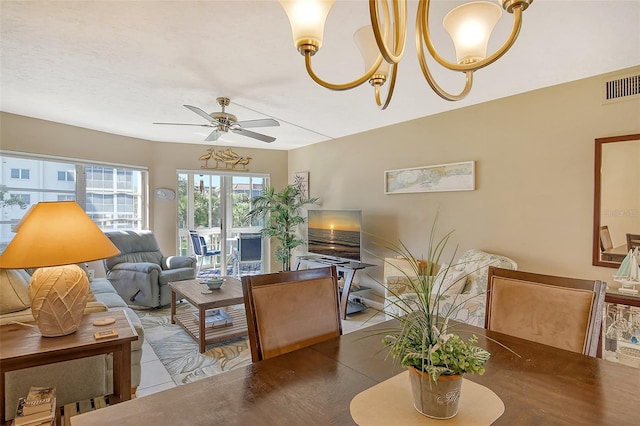 living area featuring a ceiling fan and visible vents