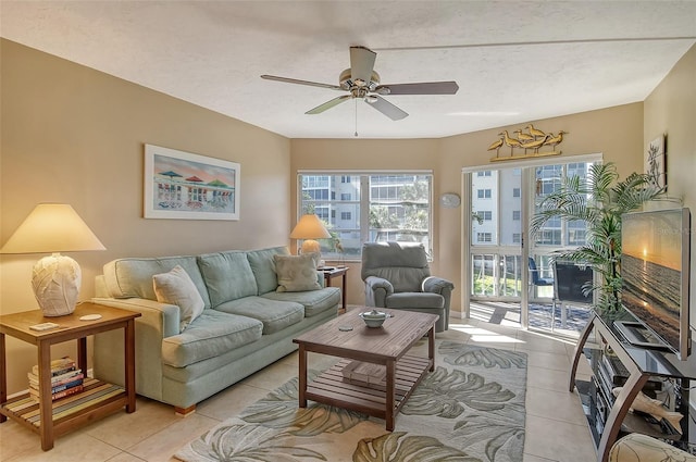 living area featuring a ceiling fan and light tile patterned floors