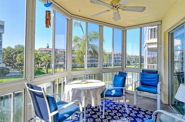 sunroom / solarium featuring a ceiling fan