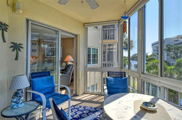 sunroom / solarium featuring a ceiling fan