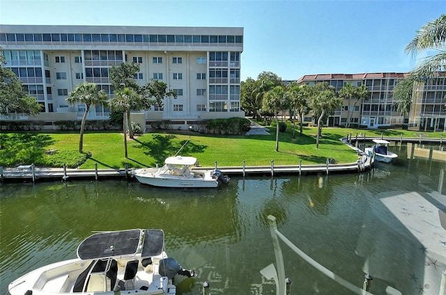 dock area with a water view and a yard