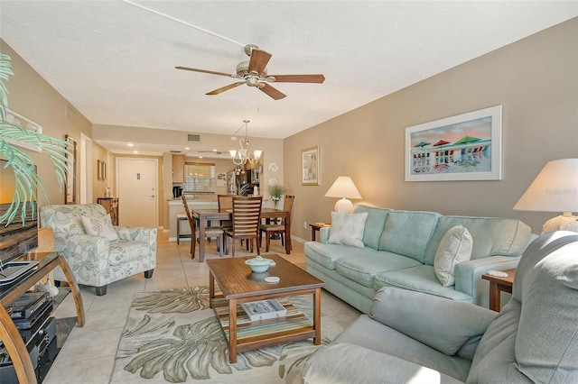 living room featuring light tile patterned floors, baseboards, visible vents, and ceiling fan with notable chandelier