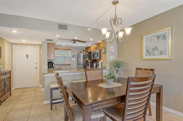 dining room featuring light tile patterned floors, visible vents, and baseboards