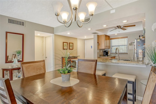 dining area featuring a textured ceiling, recessed lighting, visible vents, and a ceiling fan