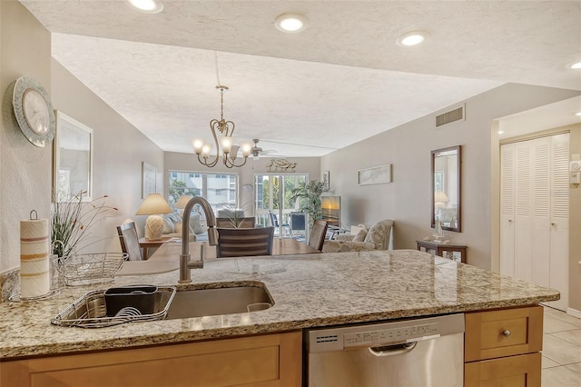 kitchen with a chandelier, light stone counters, visible vents, open floor plan, and dishwasher