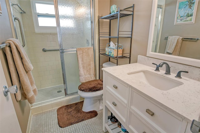 bathroom with tile patterned flooring, a shower stall, toilet, and vanity