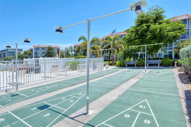 surrounding community with shuffleboard and fence