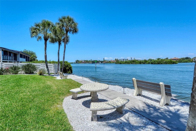 dock area with a water view and a yard