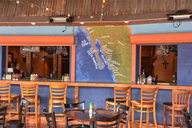 bar featuring tile patterned flooring and a community bar