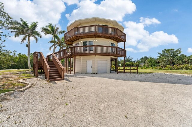 16361 Stringfellow Rd, Bokeelia, FL 33922 - view of property with a garage, stairs, and gravel driveway