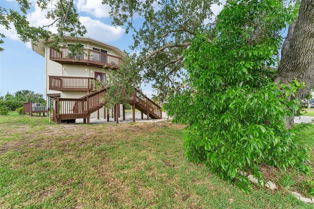 16361 Stringfellow Rd, Bokeelia, FL 33922 - rear view of house with stairway, a balcony, a lawn, and a deck