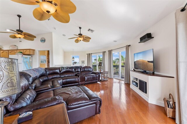 16361 Stringfellow Rd, Bokeelia, FL 33922 - living room with ceiling fan, light wood finished floors, lofted ceiling, a fireplace, and baseboards