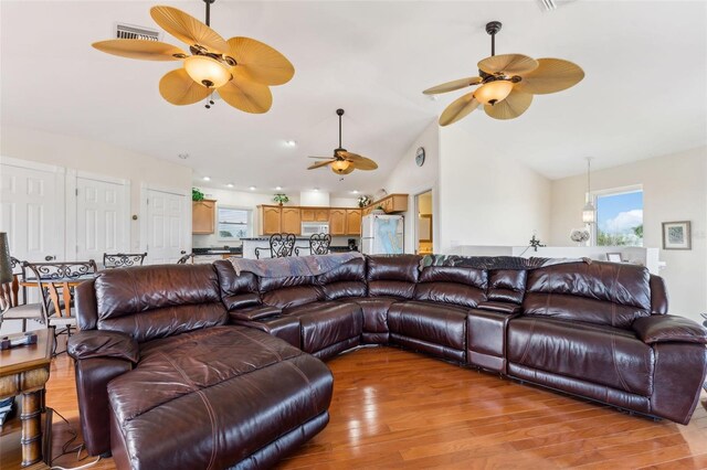 16361 Stringfellow Rd, Bokeelia, FL 33922 - living room with a ceiling fan, lofted ceiling, and light wood finished floors