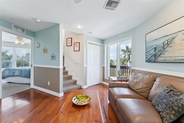 16361 Stringfellow Rd, Bokeelia, FL 33922 - living area with plenty of natural light, stairway, ceiling fan, and hardwood / wood-style flooring