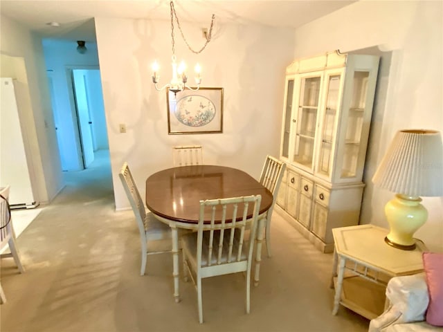 dining area with an inviting chandelier